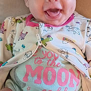 Emavere joined the competition — help win amazing prizes! apparel, baby, child, chubby_legs, clothing, comfort, cute, dinosaur_pattern, expression, face, happy, indoors, infant, onesie, playful, portrait, seated, smile, soft_surface, young