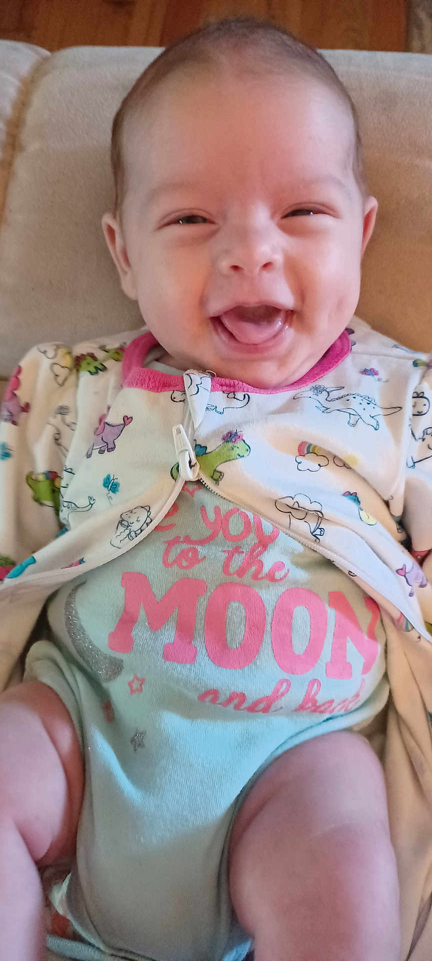 Emavere joined the competition — help win amazing prizes! apparel, baby, child, chubby_legs, clothing, comfort, cute, dinosaur_pattern, expression, face, happy, indoors, infant, onesie, playful, portrait, seated, smile, soft_surface, young