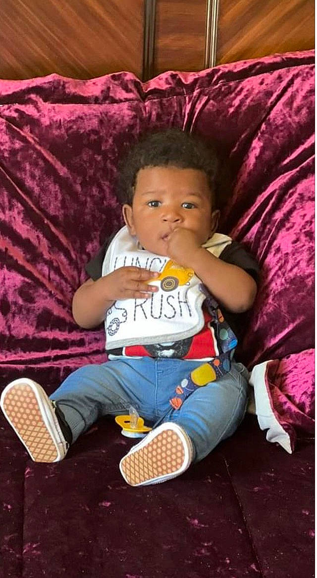 Tahir joined the competition — help win amazing prizes! baby, baby_toddler_clothing, child, comfort, cool, couch, fun, happy, lap, leisure, magenta, person, pink, product, purple, sitting, sneakers, sock, textile, thigh