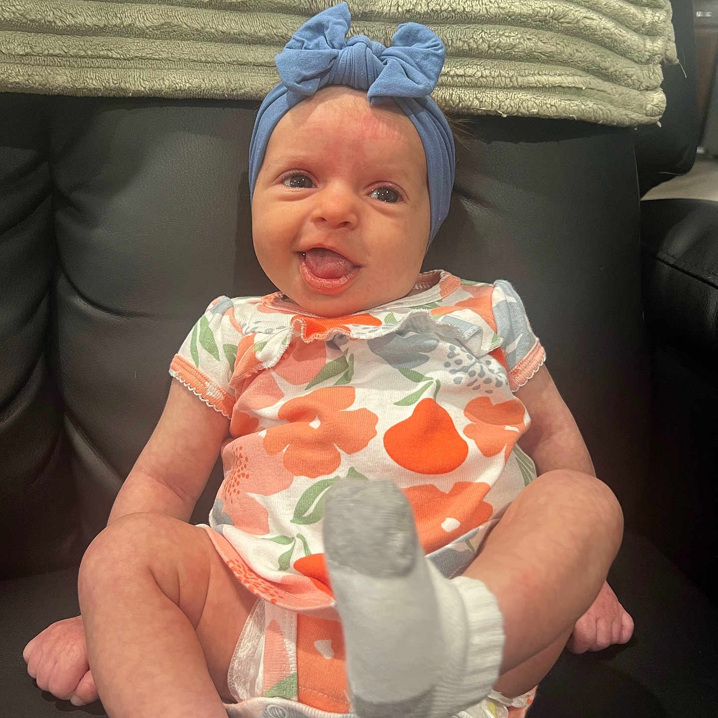 Blakely is registered to the contest to win money with this photo: baby, clothing, costume, couch, cushion, face, furniture, glove, happy, hat, head, homedecor, hosiery, newborn, person, photography, portrait, sitting, sock, t_shirt