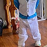 child, boy, indoors, clothing, vest, shirt, pants, shoes, toy, floor, wooden_furniture, smiling, portrait, casual, social_media, comment, happy, home, baby_gate, tie