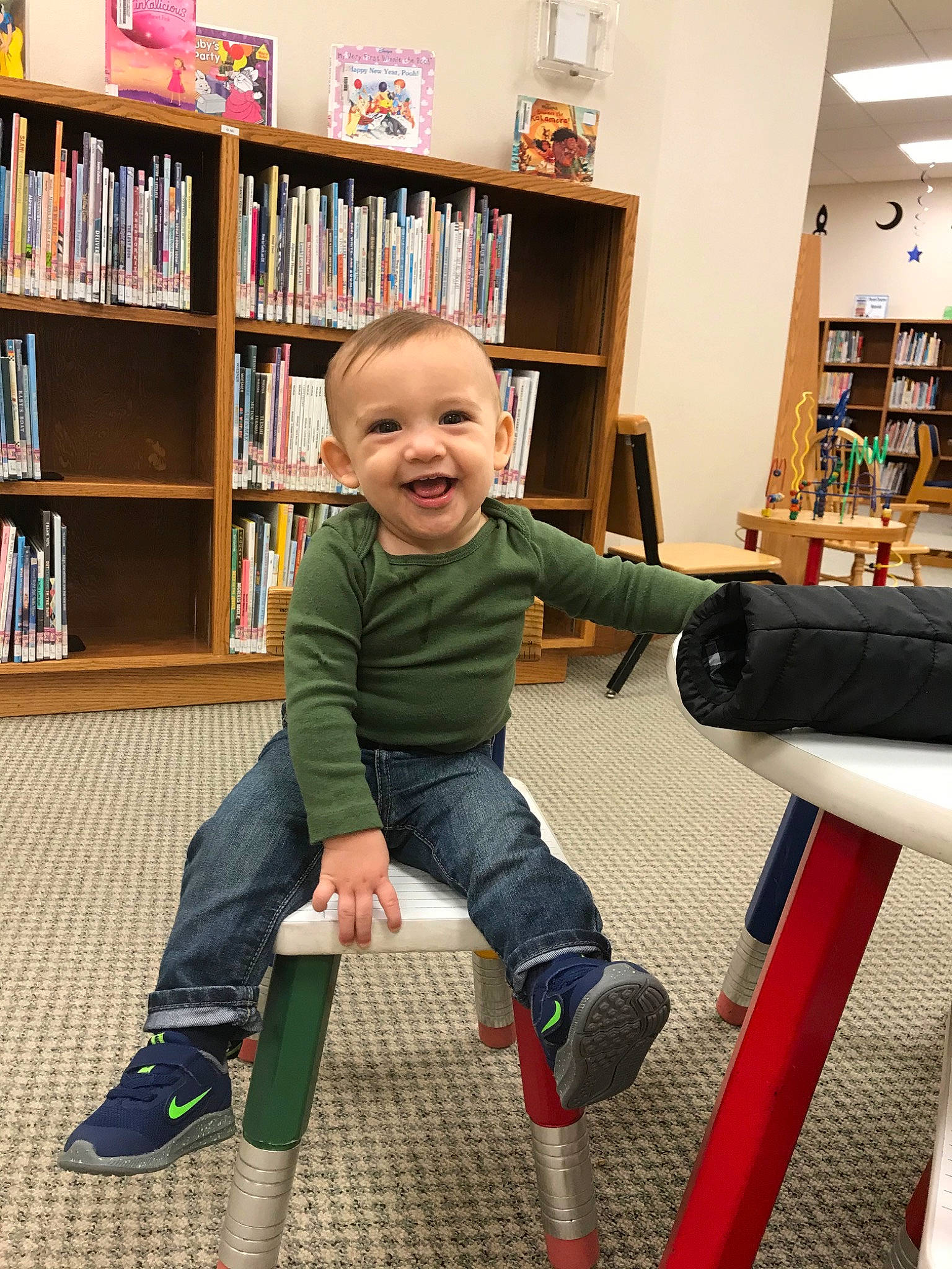 Andrei joined the competition — help win amazing prizes! baby, bookcase, child, furniture, joy, leg, library, person, play, room, shelf, shelving, shoe, sitting, smile, standing, toddler