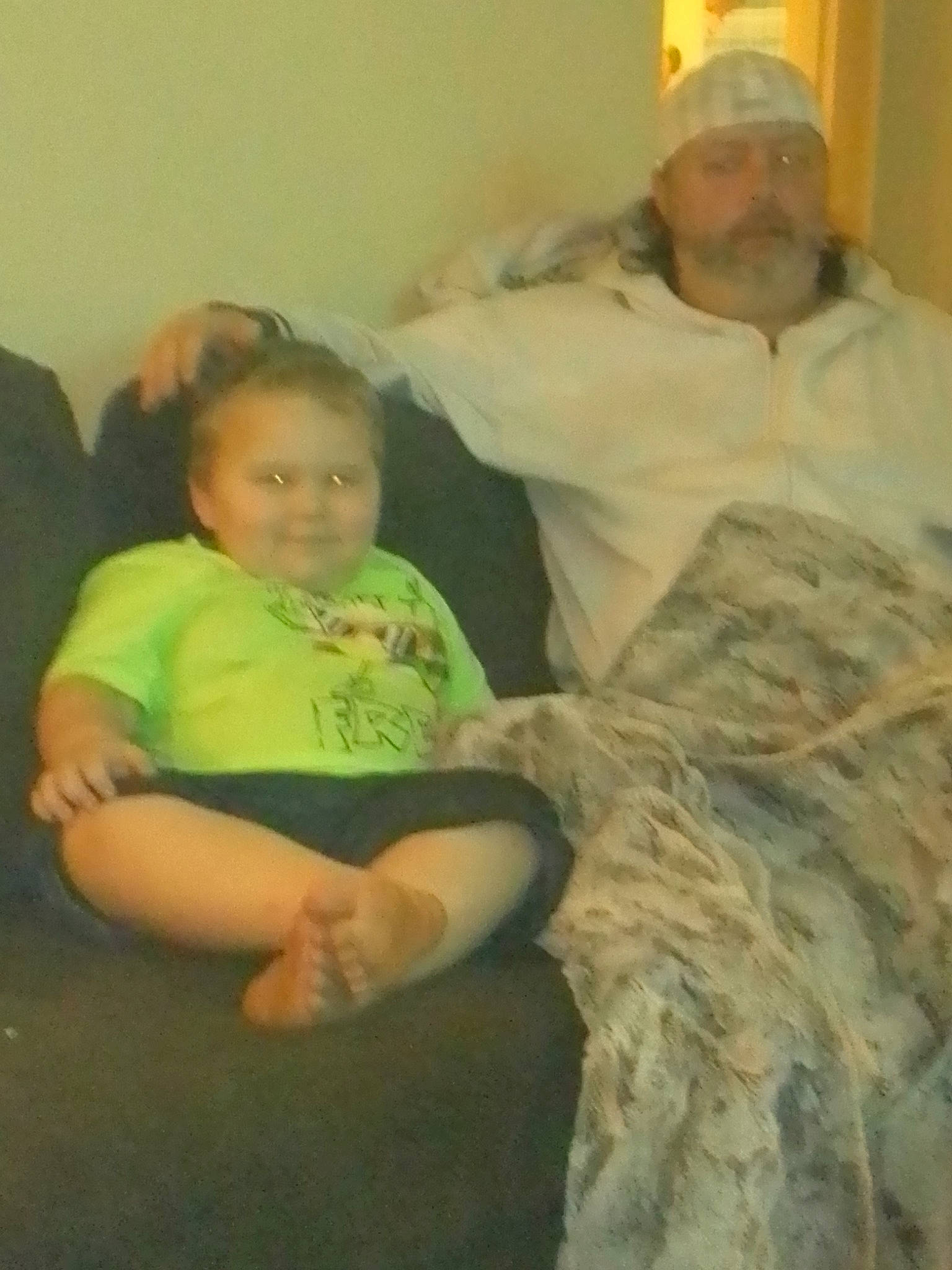 Remington is registered to the contest to win money with this photo: baby, child, comfort, event, fun, fur, happy, hat, headwear, joy, lap, person, room, sitting, smile, t_shirt, toddler