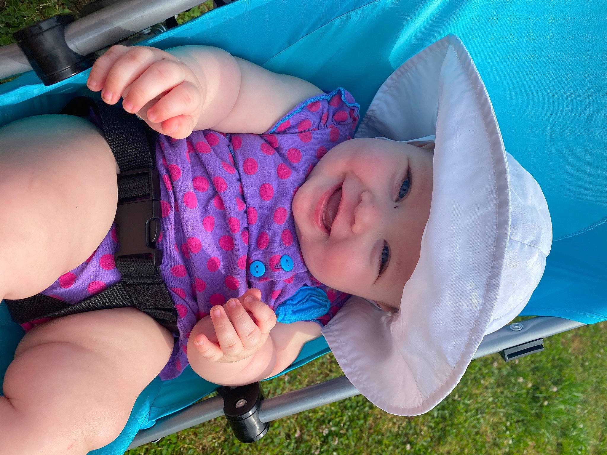 Alaysia is registered to the contest to win money with this photo: arm, baby, child, finger, grass, hand, headwear, leg, mouth, nose, person, plant, play, product, toddler, vacation