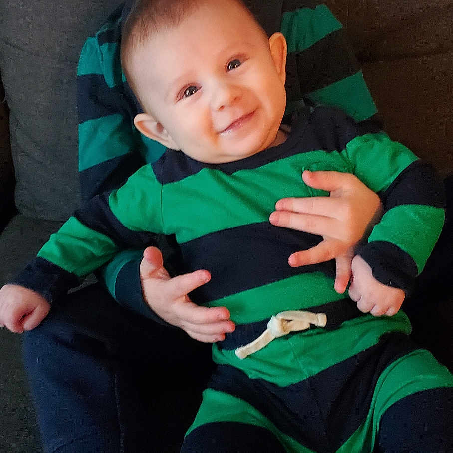 Liam is registered to the contest to win money with this photo: baby, bodypart, clothing, couch, cushion, face, finger, furniture, hand, happy, head, homedecor, pants, people, person, photography, portrait, shorts, sitting, smile