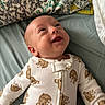 Grayson joined the competition — help win amazing prizes! baby, infant, child, smiling, happy, face, portrait, lying_down, bed, bedding, blanket, pillow, onesie, teddy_bear_pattern, clothing, indoor, cozy, close_up, photography, nursery