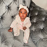 Romani joined the competition — help win amazing prizes! baby, infant, child, portrait, sitting, sofa, couch, tufted_furniture, gray, headband, bow, pink, onesie, baby_clothing, wide_eyed, looking_at_camera, indoor, home, photography, adorable