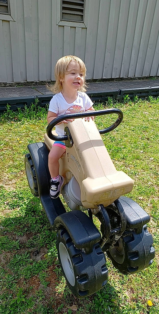 Kenley joined the competition — help win amazing prizes! auto_part, automotive_design, automotive_tire, automotive_wheel_system, baby_toddler_clothing, child, fender, grass, lawn, motor_vehicle, person, photograph, recreation, riding_toy, rolling, smile, tire, toddler, tread, vehicle