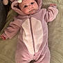 baby, infant, onesie, costume, hood, purple, soft, blanket, cute, lying_down, face, ears, fuzzy, child, person, indoor, cozy, expression, feet, zipped