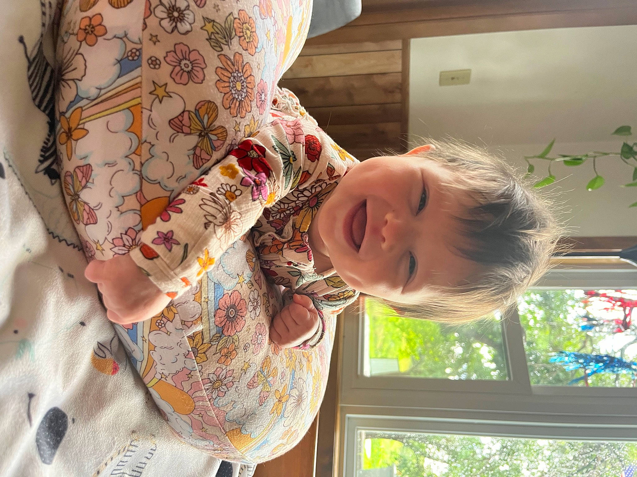 Lexi is registered to the contest to win money with this photo: baby, baby_toddler_clothing, child, fun, happy, linens, pattern, person, room, skin, sleeve, smile, toddler, visual_arts, window