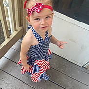 Bryonna joined the competition — help win amazing prizes! toddler, child, girl, dress, headband, red, white, blue, stars, stripes, porch, wooden_floor, outdoor, person, smile, curious, hair_up, summer, casual, cute