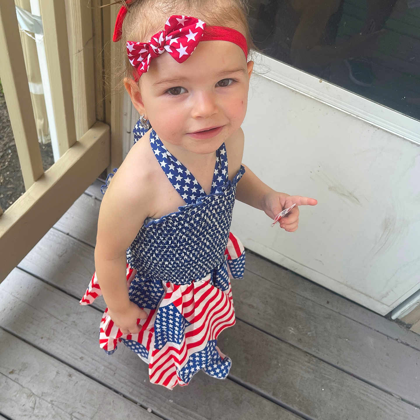 Bryonna joined the competition — help win amazing prizes! toddler, child, girl, dress, headband, red, white, blue, stars, stripes, porch, wooden_floor, outdoor, person, smile, curious, hair_up, summer, casual, cute