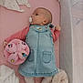 Naomi a rejoint le concours — aidez-le/la à gagner de superbes lots ! baby, pacifier, denim_dress, pink_mattress, toy, cartoon_characters, blanket, crib, infant, sleepwear, cute, child, soft_toy, mesh_crib_side, white_blanket, pink, lying_down, indoors, young_child, comfort