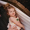 child, girl, hammock, outdoor, relaxing, smiling, hair_clip, hand, watch, arm, casual_clothing, nature, garden, portrait, cute, comfort, family, toddler, person, summer