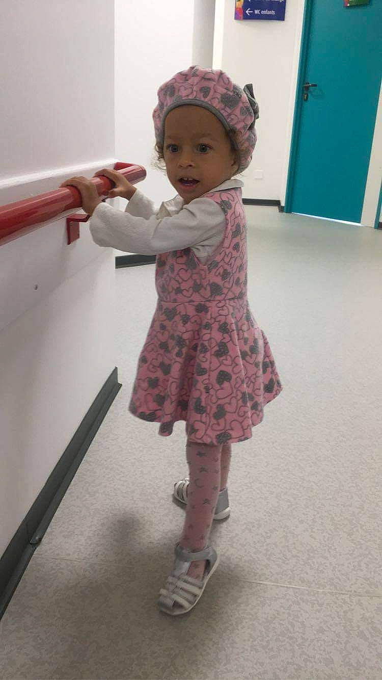 Nina participe au concours pour gagner de l'argent avec cette photo : baby, cheek, child, dress, footwear, head, headwear, person, pink, play, room, shoe, skin, standing, toddler, toy