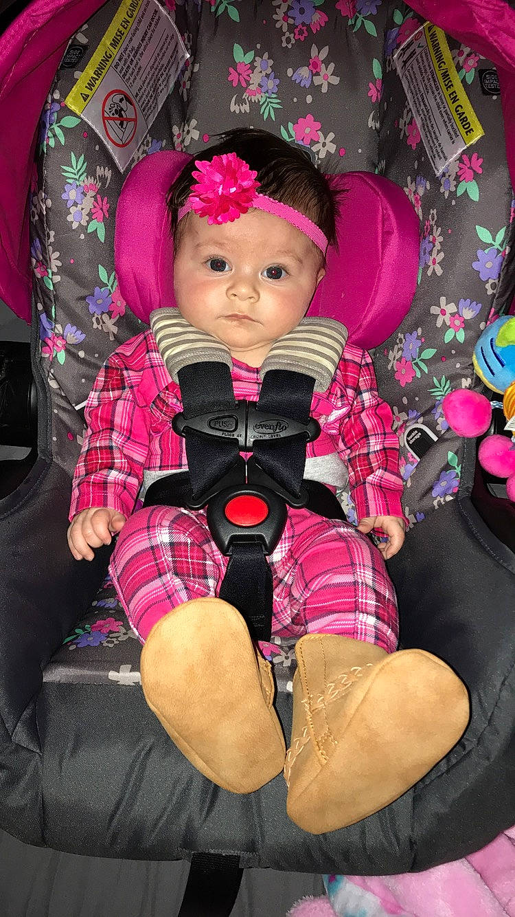 Emarie is registered to the contest to win money with this photo: auto_part, car_seat, child, pattern, person, photography, pink, plaid, sitting, toddler