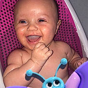 Amelia James joined the competition — help win amazing prizes! baby, child, smiling, laughing, bath, bathtub, toy, butterfly_toy, water, wet_skin, pink, purple, blue, happy, infant, cute, playful, sitting, indoors, closeup