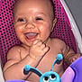 baby, child, smiling, laughing, bath, bathtub, toy, butterfly_toy, water, wet_skin, pink, purple, blue, happy, infant, cute, playful, sitting, indoors, closeup