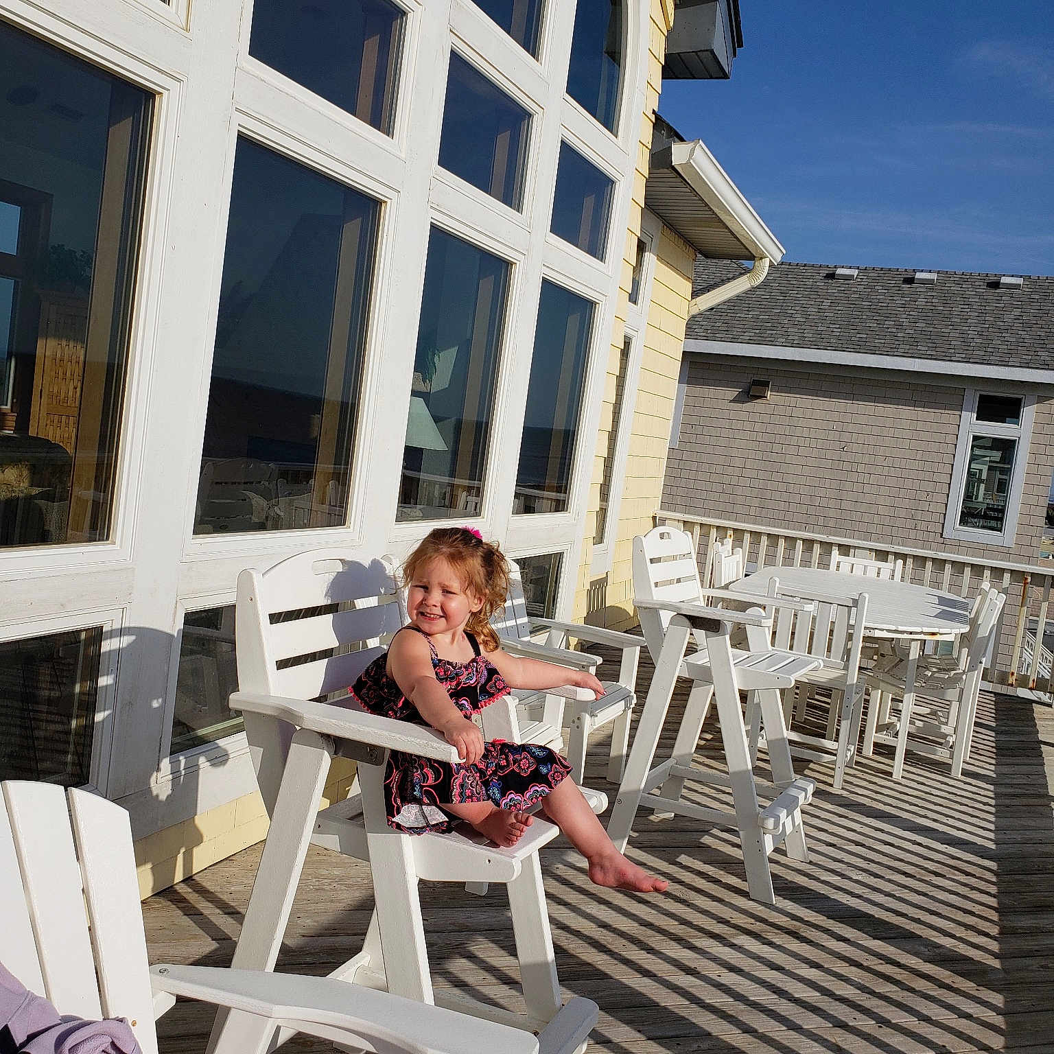 Ziva is registered to the contest to win money with this photo: balcony, building, fun, home, house, joy, leisure, outdoor_furniture, person, property, real_estate, sitting, tourism, vacation, white, window