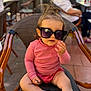 Mylia a rejoint le concours — aidez-le/la à gagner de superbes lots ! cafe, casual, chair, child, coin, cute, daytime, fashion, footwear, hair_tuft, outdoor, patterned_chair, person, pink_clothing, seated, sneakers, sunglasses, sunny, toddler, young_child