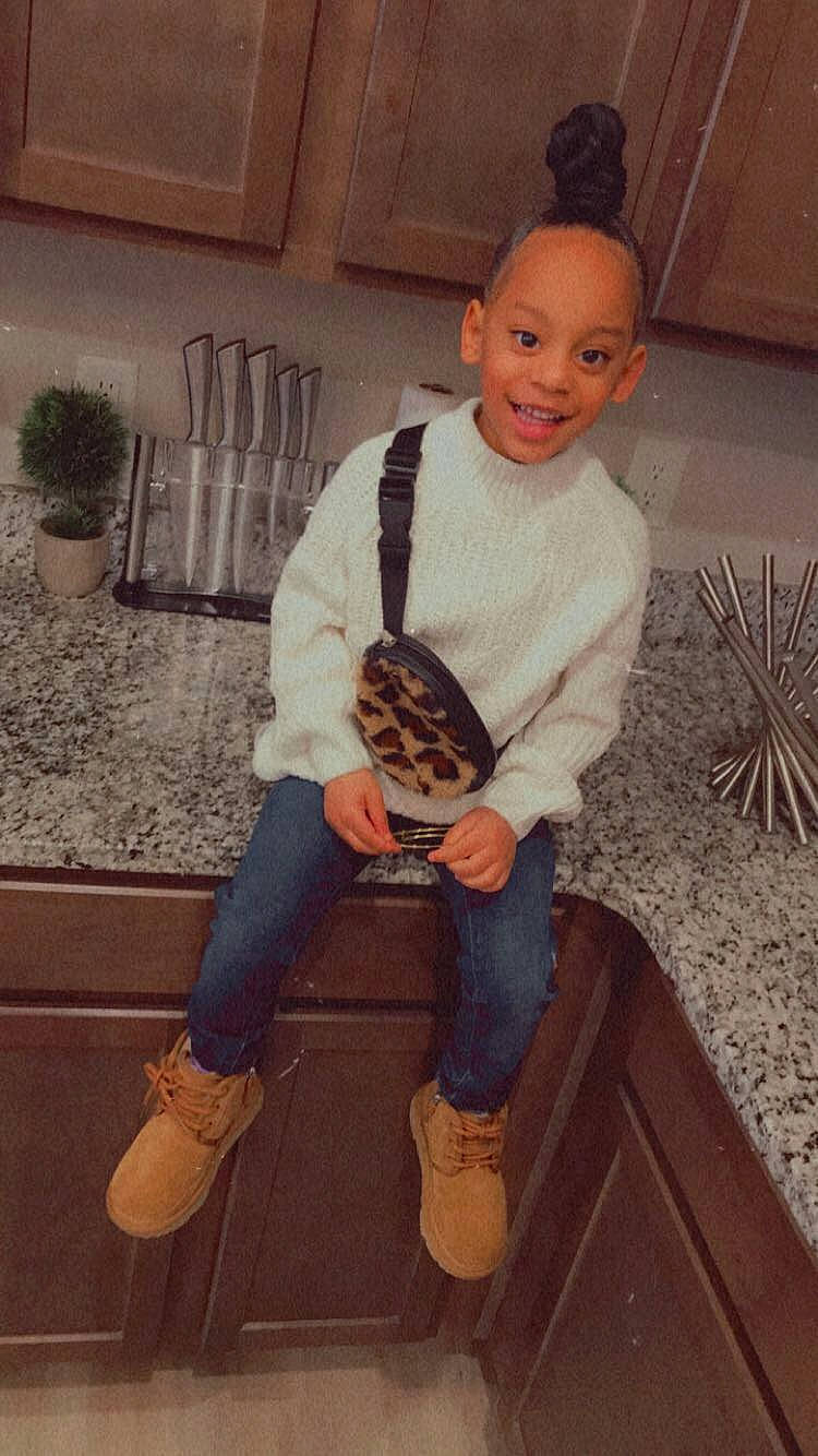 Londynn joined the competition — help win amazing prizes! baby_toddler_clothing, chair, cool, denim, flooring, footwear, fun, hardwood, houseplant, jeans, joy, knee, leg, person, plant, shoe, sleeve, smile, sneakers, t_shirt