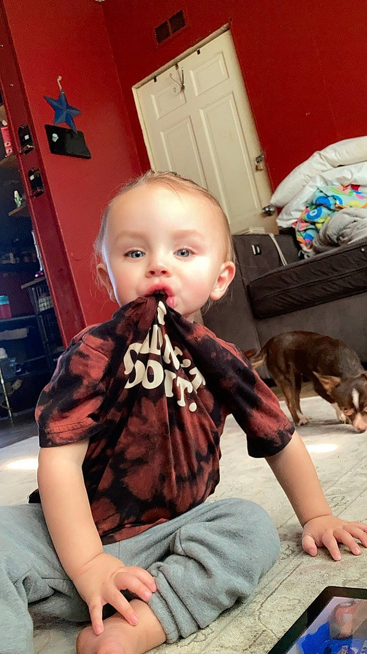 Roman Keen is registered to the contest to win money with this photo: baby, beard, cabinetry, carnivore, chair, child, companion_dog, dessert, dog, eating, facial_hair, flooring, fun, holiday, muscle, person, refrigerator, room, sitting, t_shirt