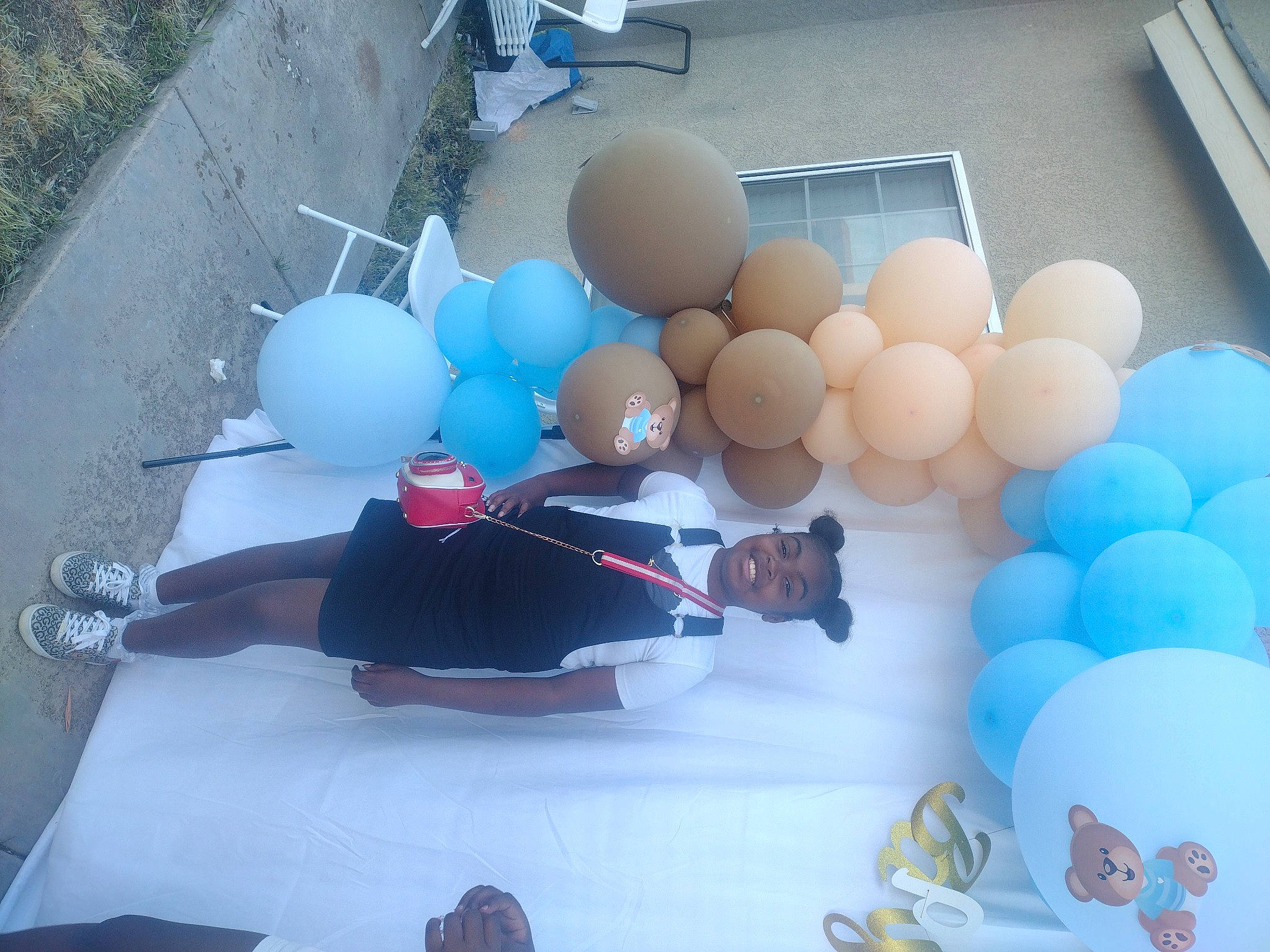 Bria is registered to the contest to win money with this photo: arch, balloon, blue, event, fun, joy, leisure, party, party_supply, person, plastic, recreation, suit, toy, window