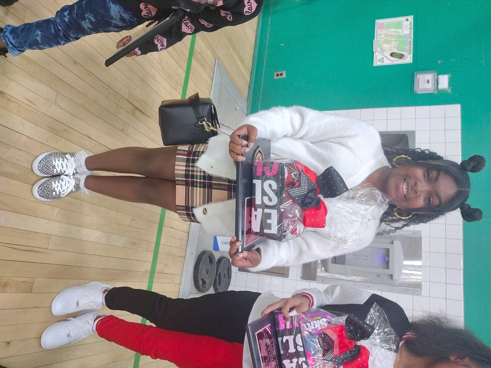 Bria is registered to the contest to win money with this photo: black, boot, costume, event, fun, hardwood, human_leg, joy, knee, person, room, smile, sock, thigh, walking_shoe, white, wood