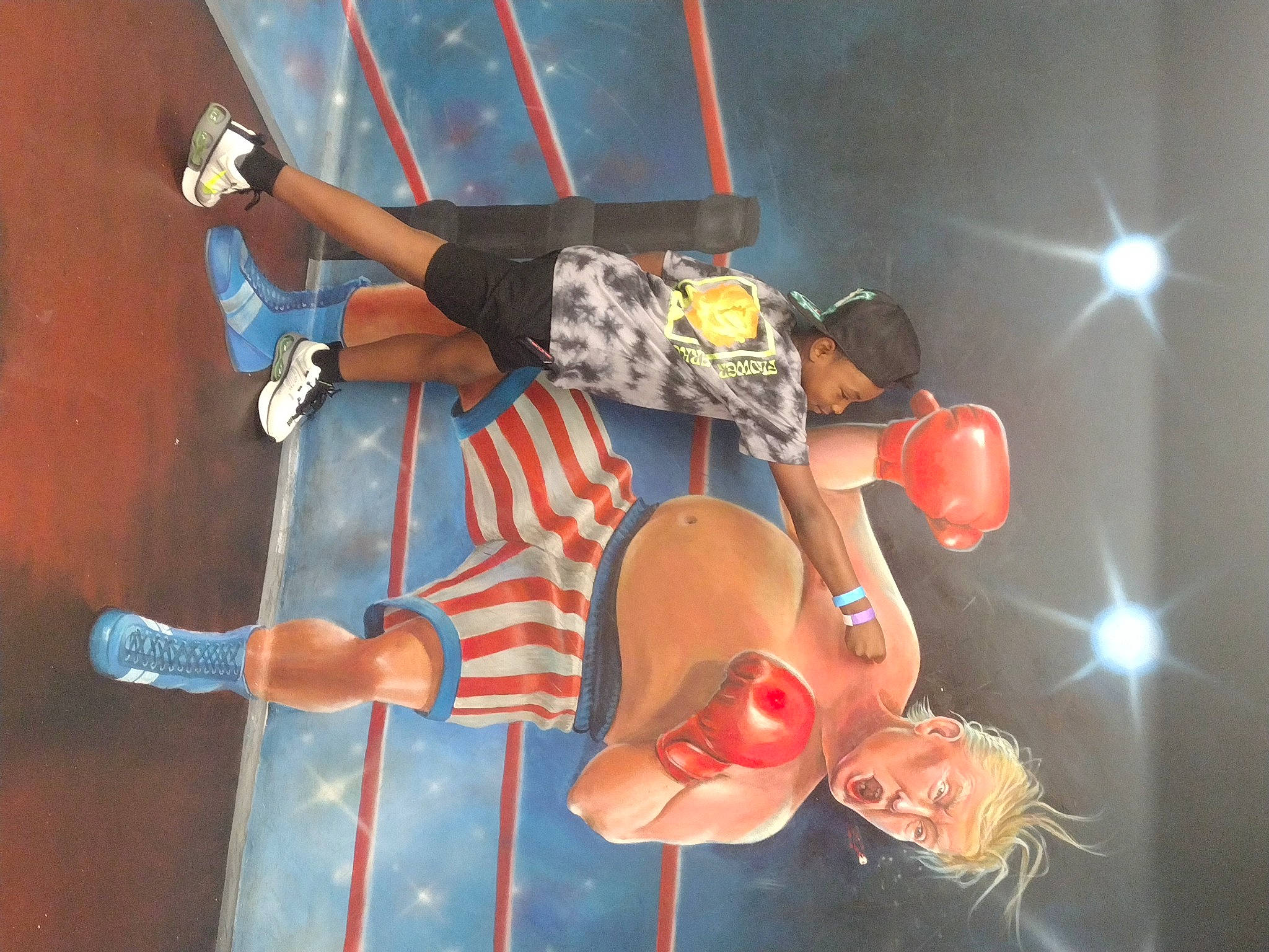 Nolan is registered to the contest to win money with this photo: artist, boot, elbow, entertainment, event, footwear, fun, hat, human_leg, knee, leg, leisure, music, musician, orange, performance_art, performing_arts, person, shorts, sneakers