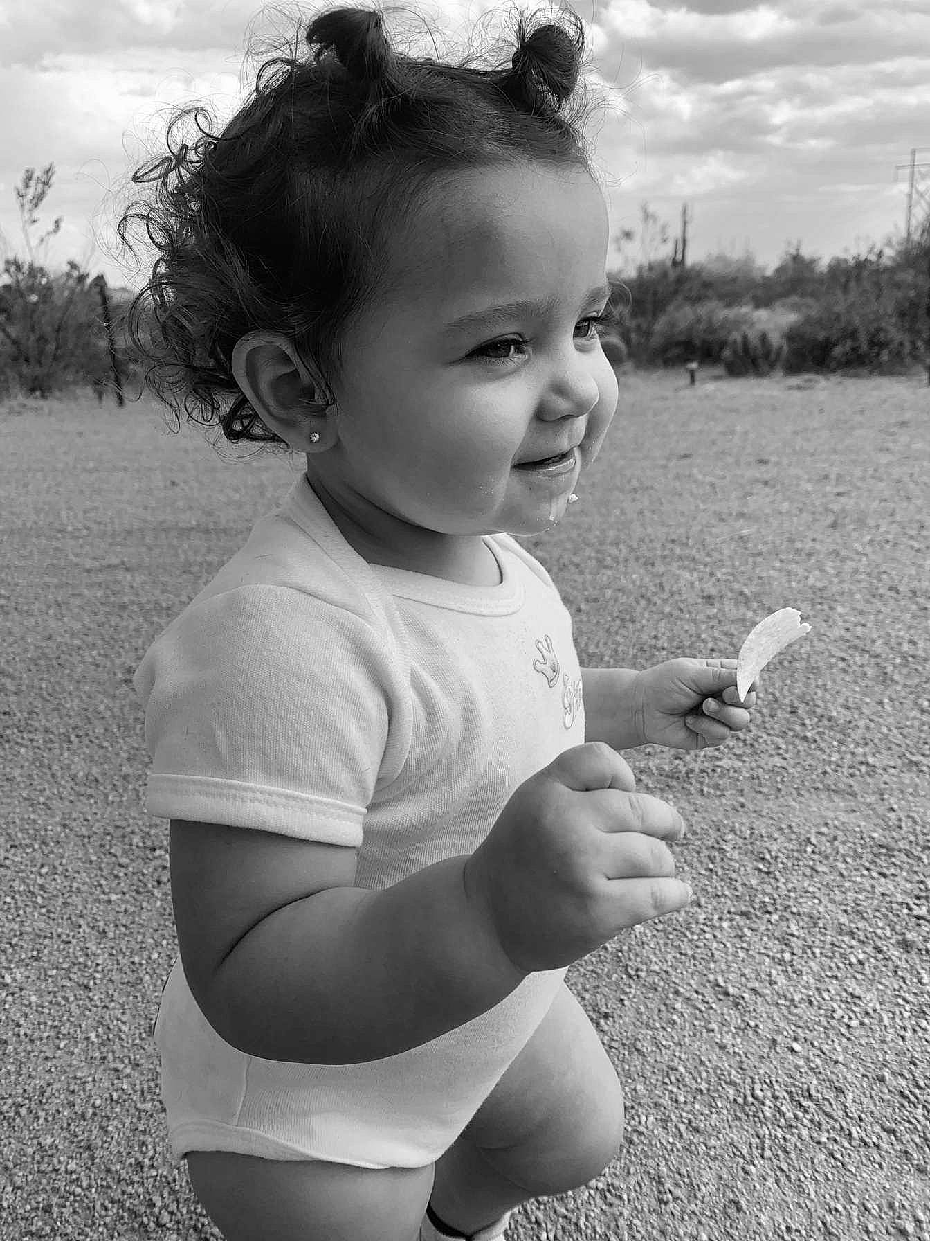 Amanda is registered to the contest to win money with this photo: arm, beauty, black, black_and_white, child, face, grass, hairstyle, head, joint, lip, monochrome, monochrome_photography, person, photograph, shoulder, skin, smile, snapshot, standing
