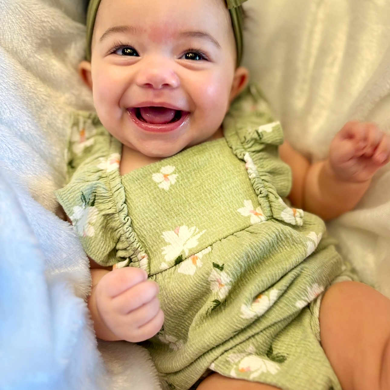 Anlyn joined the competition — help win amazing prizes! baby, blanket, child, close_up, cute, eyes, face, floral_pattern, green_headband, green_outfit, hand, happy, head, infant, lying_down, mouth, portrait, skin, smiling, soft_texture