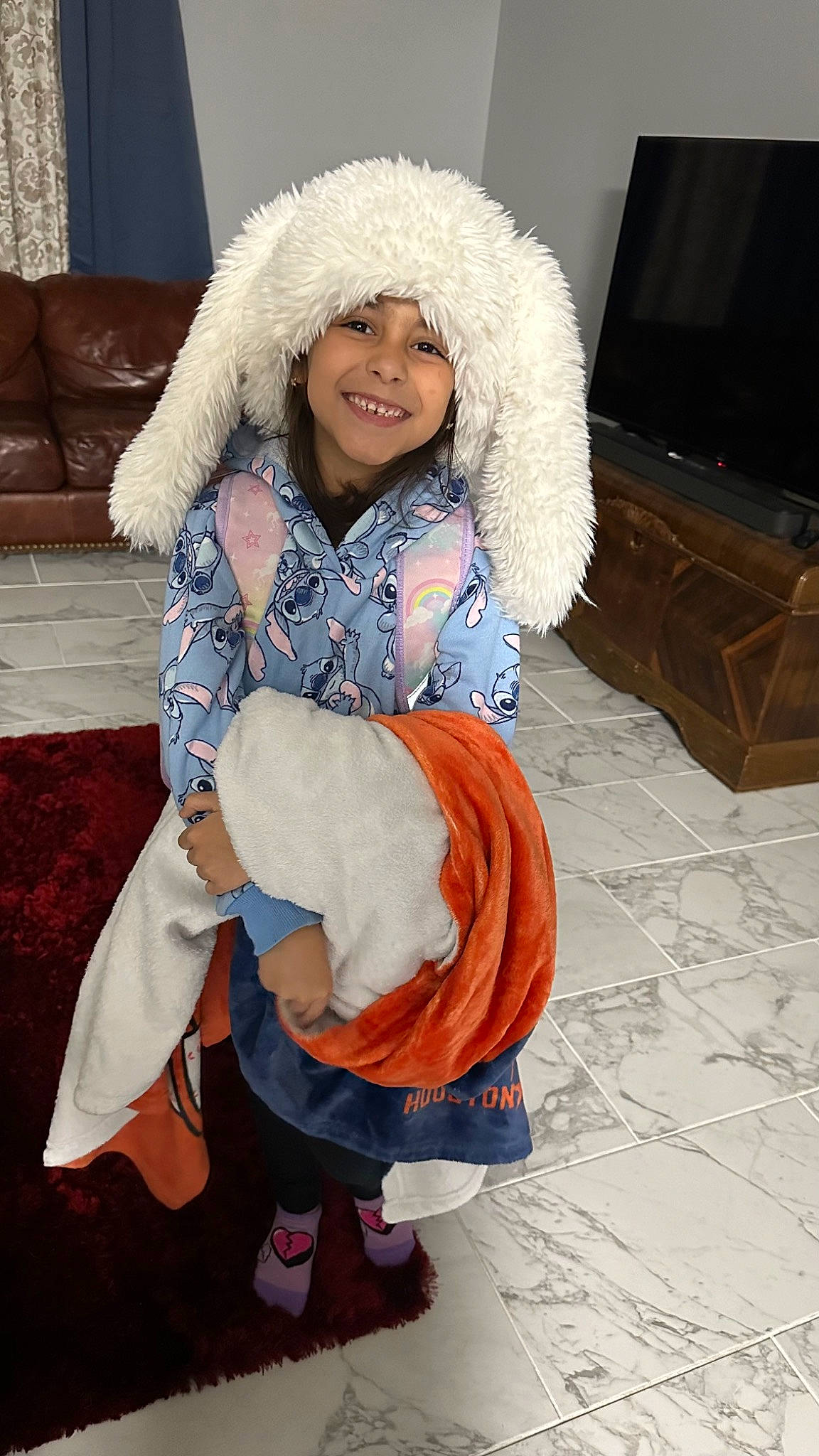 Arielle joined the competition — help win amazing prizes! boot, child, costume, electric_blue, event, eye, face, flooring, fun, fur, fur_clothing, happy, headwear, human_leg, joy, lap, person, shipping_box, sitting, smile