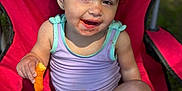 Brooklynn is registered to the contest to win money with this photo: toddler, child, snack, cheese_puff, messy_face, red_chair, outdoor, smiling, summer_clothing, sitting, barefoot, cute, happy, sunlight, diaper, casual, playful, young_child, portrait, daylight
