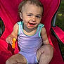 toddler, child, snack, cheese_puff, messy_face, red_chair, outdoor, smiling, summer_clothing, sitting, barefoot, cute, happy, sunlight, diaper, casual, playful, young_child, portrait, daylight