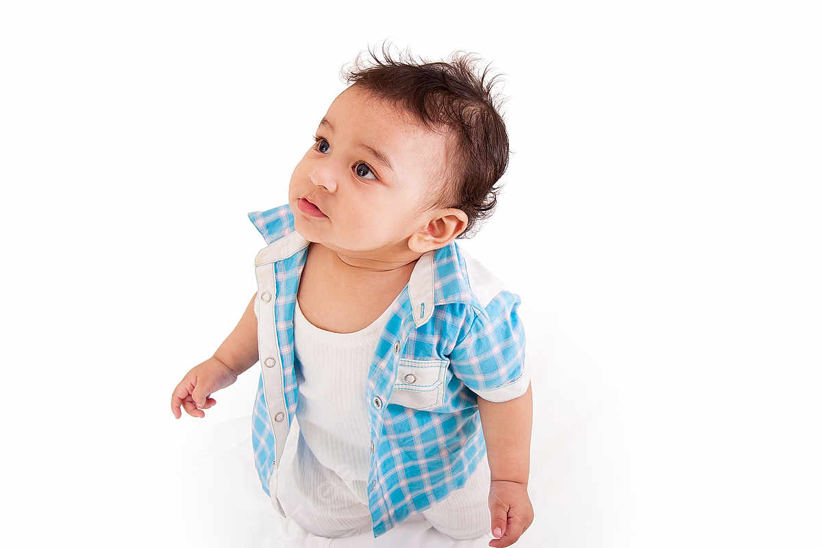 Dabur joined the competition — help win amazing prizes! baby, child, infant, blue_shirt, white_outfit, curious, standing, portrait, studio, isolated, cute, looking_up, short_hair, small_hands, innocence, expression, clothing, baby_boy, casual_wear, white_background