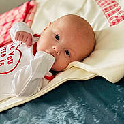 Carson joined the competition — help win amazing prizes! baby, bed, biting, blanket, crib, face, furniture, happy, head, infantbed, newborn, person, photography, portrait, smile, yawning