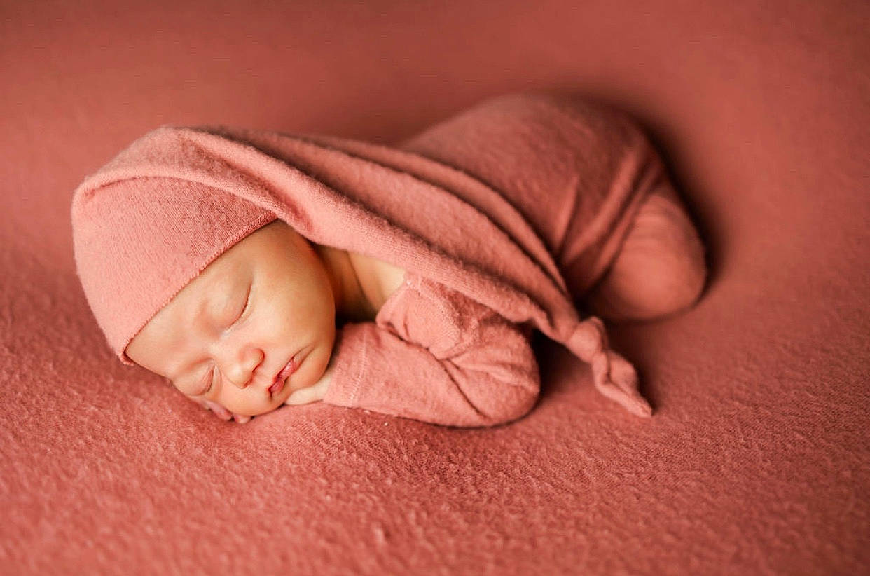 Iris is registered to the contest to win money with this photo: baby, baby_sleeping, baby_toddler_clothing, bedtime, carmine, child, close_up, comfort, face, finger, flesh, flooring, head, headwear, linens, peach, person, portrait_photography, sleep, sleeve
