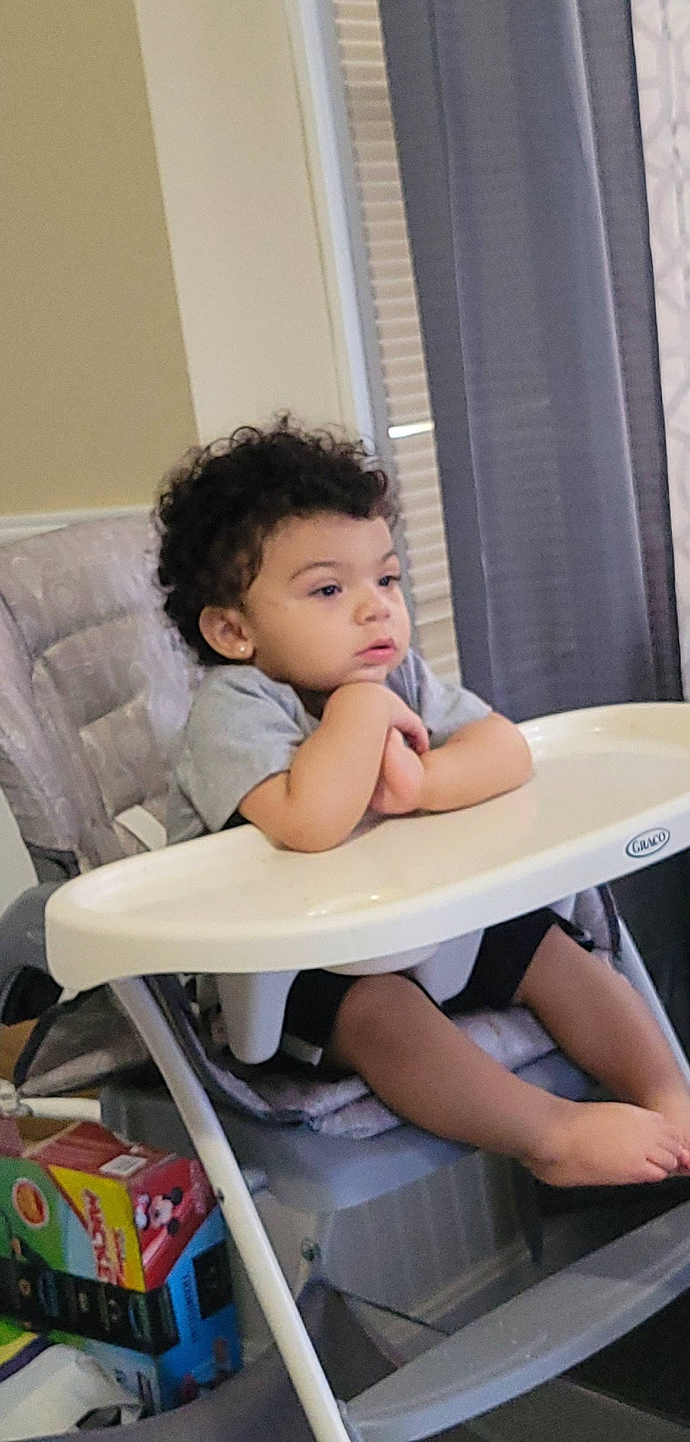 Marcel joined the competition — help win amazing prizes! baby_toddler_clothing, black_hair, chair, chin, comfort, facial_expression, finger, fun, furniture, hairstyle, happy, human, human_leg, leisure, person, shoe, skin, standing, table, thigh