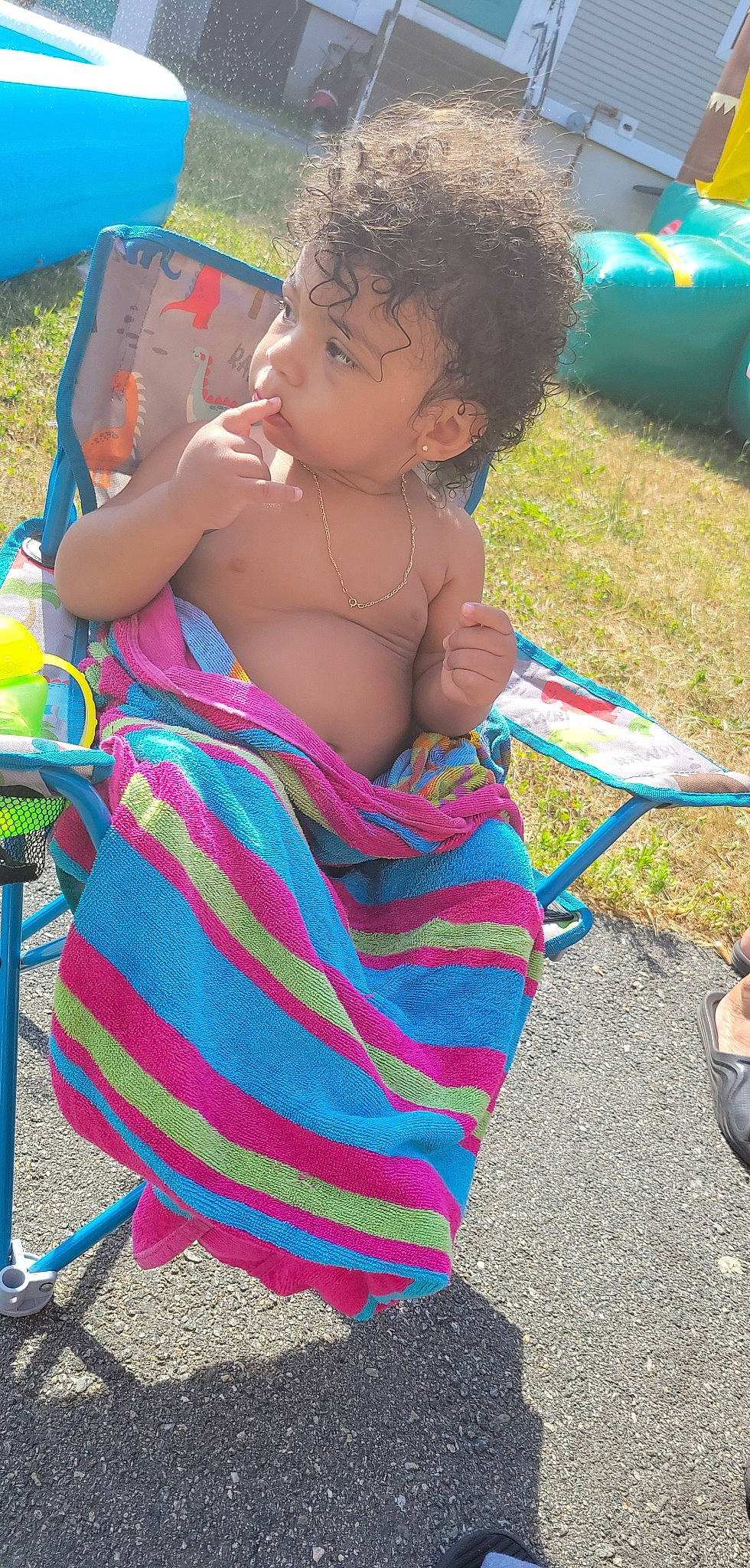 Marcel is registered to the contest to win money with this photo: blue, child, electric_blue, event, fun, grass, green, hairstyle, leisure, magenta, pattern, person, photograph, pink, play, recreation, sandal, sitting, snapshot, summer