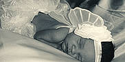 Angel is registered to the contest to win money with this photo: newborn, baby, sleeping, headband, flower, lace, skirt, fabric, soft, portrait, infant, peaceful, monochrome, closeup, cute, tiny, resting, delicate, tender, child