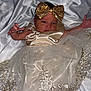 Angel is registered to the contest to win money with this photo: baby, infant, dress, bow, golden, sequins, fabric, blanket, newborn, cute, portrait, child, lying_down, hand, face, headwear, delicate, soft, adorable, elegant