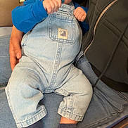 Adam a rejoint le concours — aidez-le/la à gagner de superbes lots ! baby, pacifier, blue_overalls, socks, indoor, child, person, cushion, chair, hand, jeans, face, seated, cute, infant, holding, clothing, wooden_furniture, expression, closeup