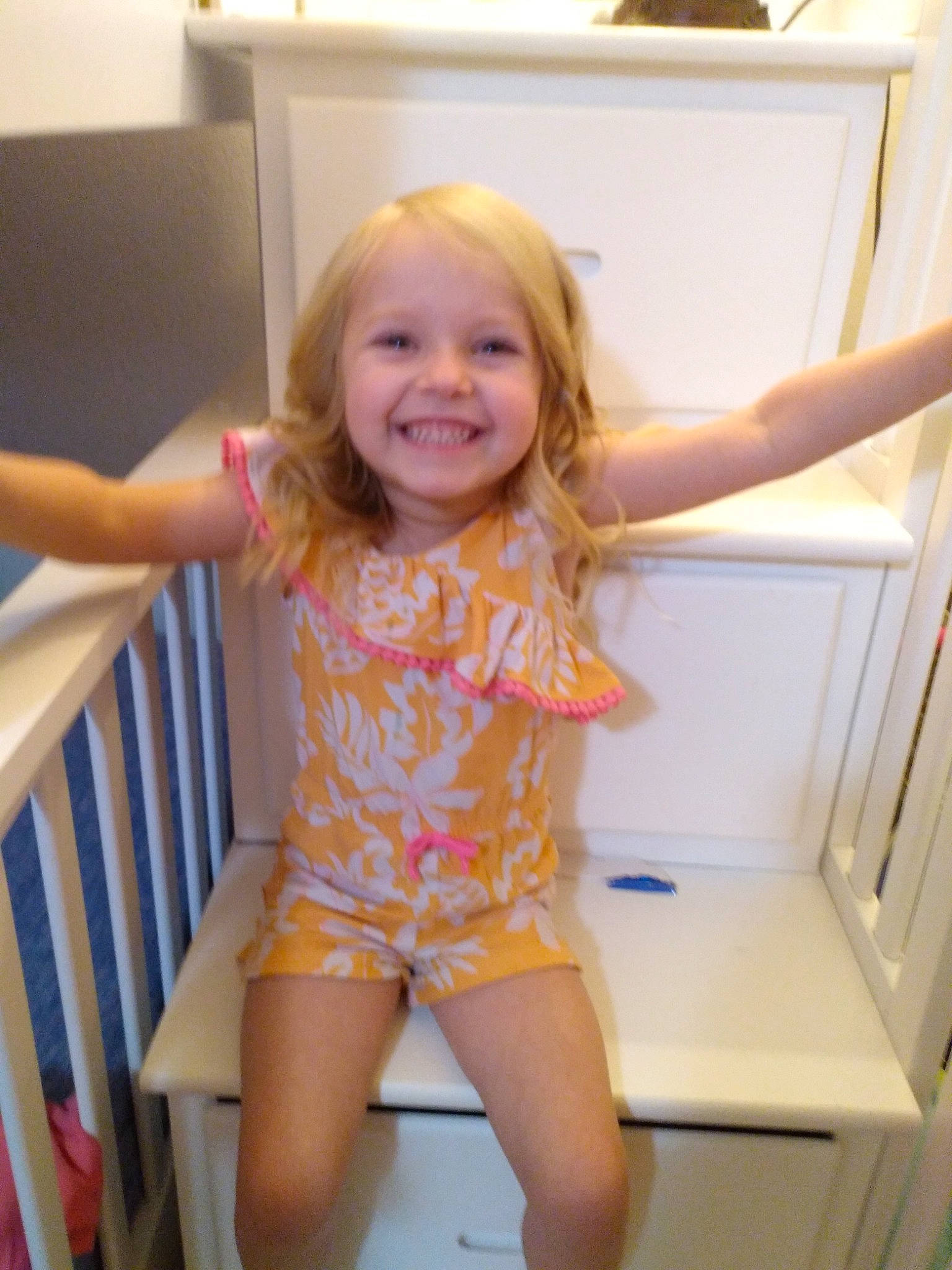 Harlow is registered to the contest to win money with this photo: finger, fun, hair, hairstyle, happy, human_body, jean_short, joint, joy, knee, leg, person, shorts, shoulder, skin, smile, standing, thigh, thumb, toddler