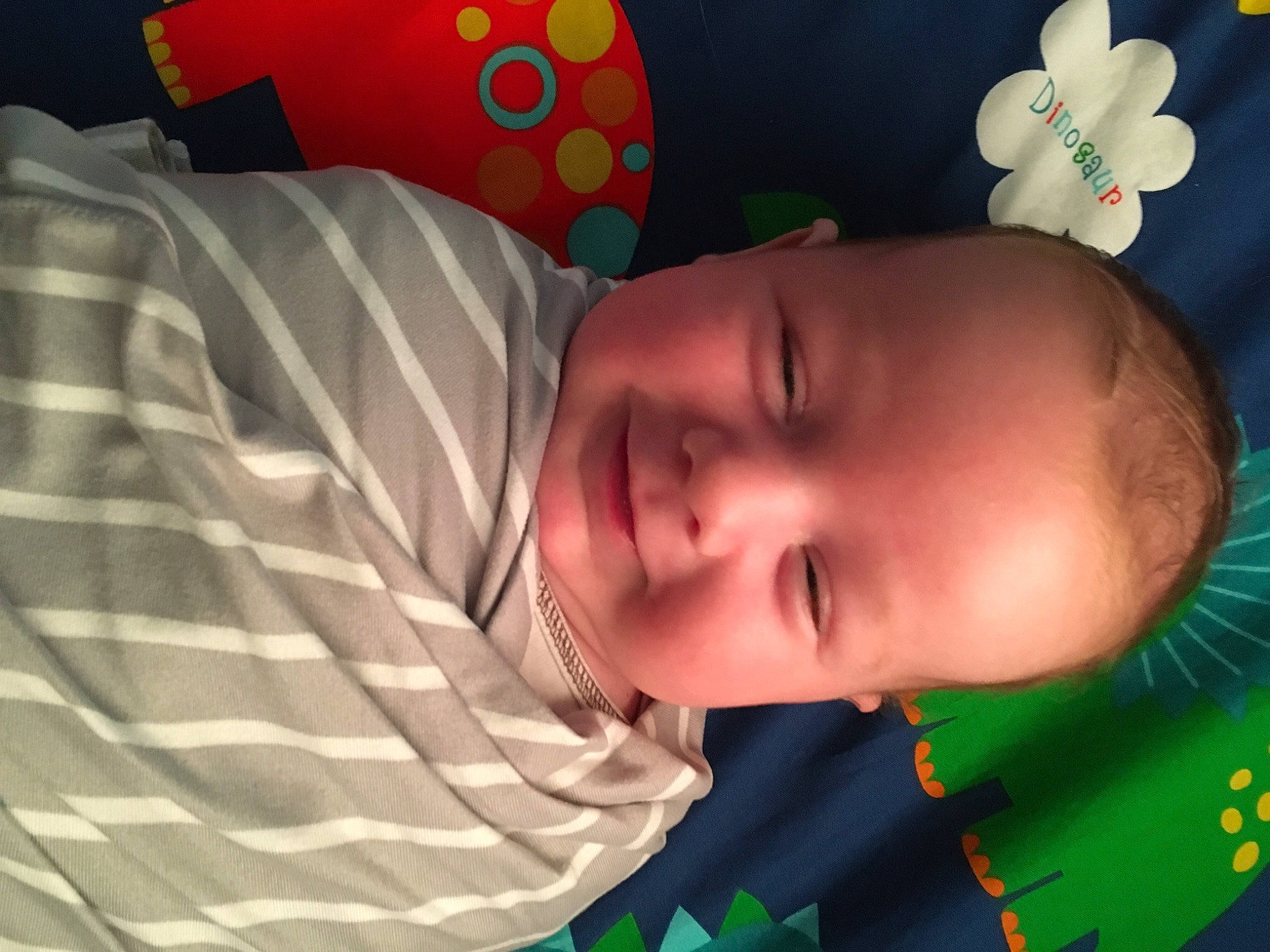 Drew is registered to the contest to win money with this photo: arm, baby, baby_products, baby_toddler_clothing, cheek, child, comfort, eye, fun, green, happy, head, joy, mouth, nose, pattern, person, skin, smile, textile