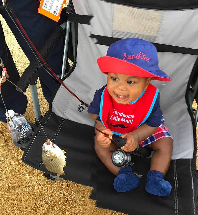 Jamir is registered to the contest to win money with this photo: bag, baseball_cap, boot, cap, carmine, child, electric_blue, fashion_accessory, fun, grass, hat, headgear, headwear, leisure, luggage_and_bags, person, product, recreation, shorts, sneakers