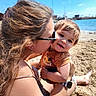 Hayden a rejoint le concours — aidez-le/la à gagner de superbes lots ! baby, beach, casual, child, family, happy, holding, kiss, love, nature, outdoor, portrait, sand, sea, sky, summer, sunglasses, sunny, vacation, woman
