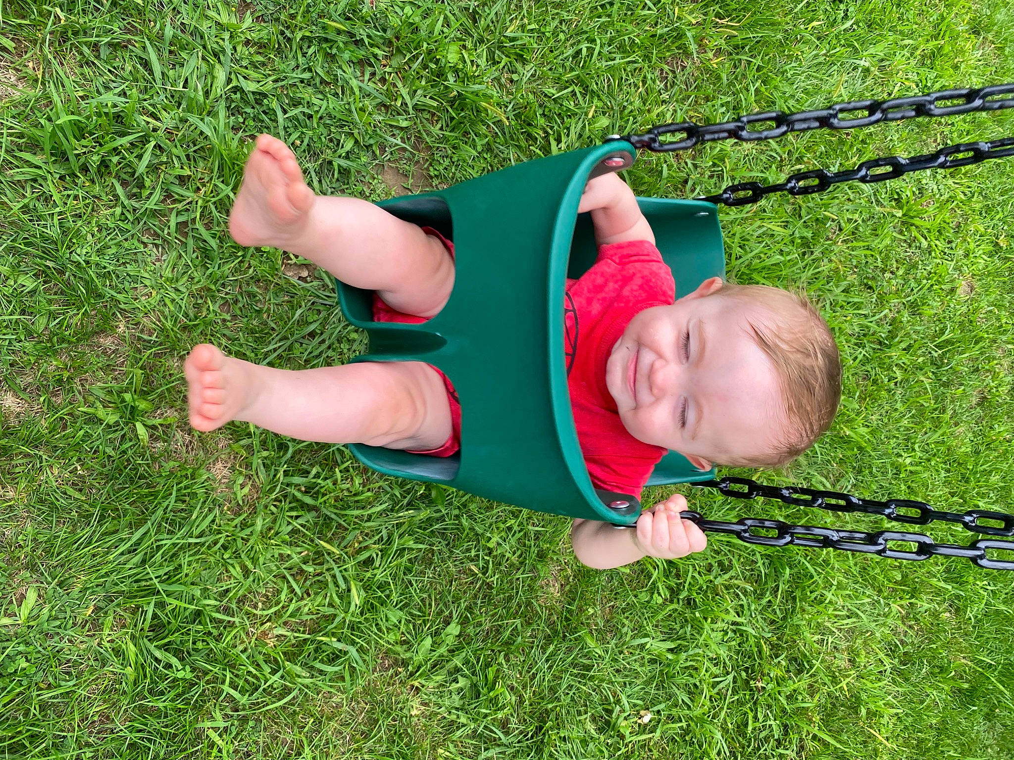 Gatlin joined the competition — help win amazing prizes! baby, child, fun, garden, grass, grass_family, grassland, happy, landscape, lawn, leisure, people_in_nature, person, plant, play, recreation, sitting, smile, swing, toddler