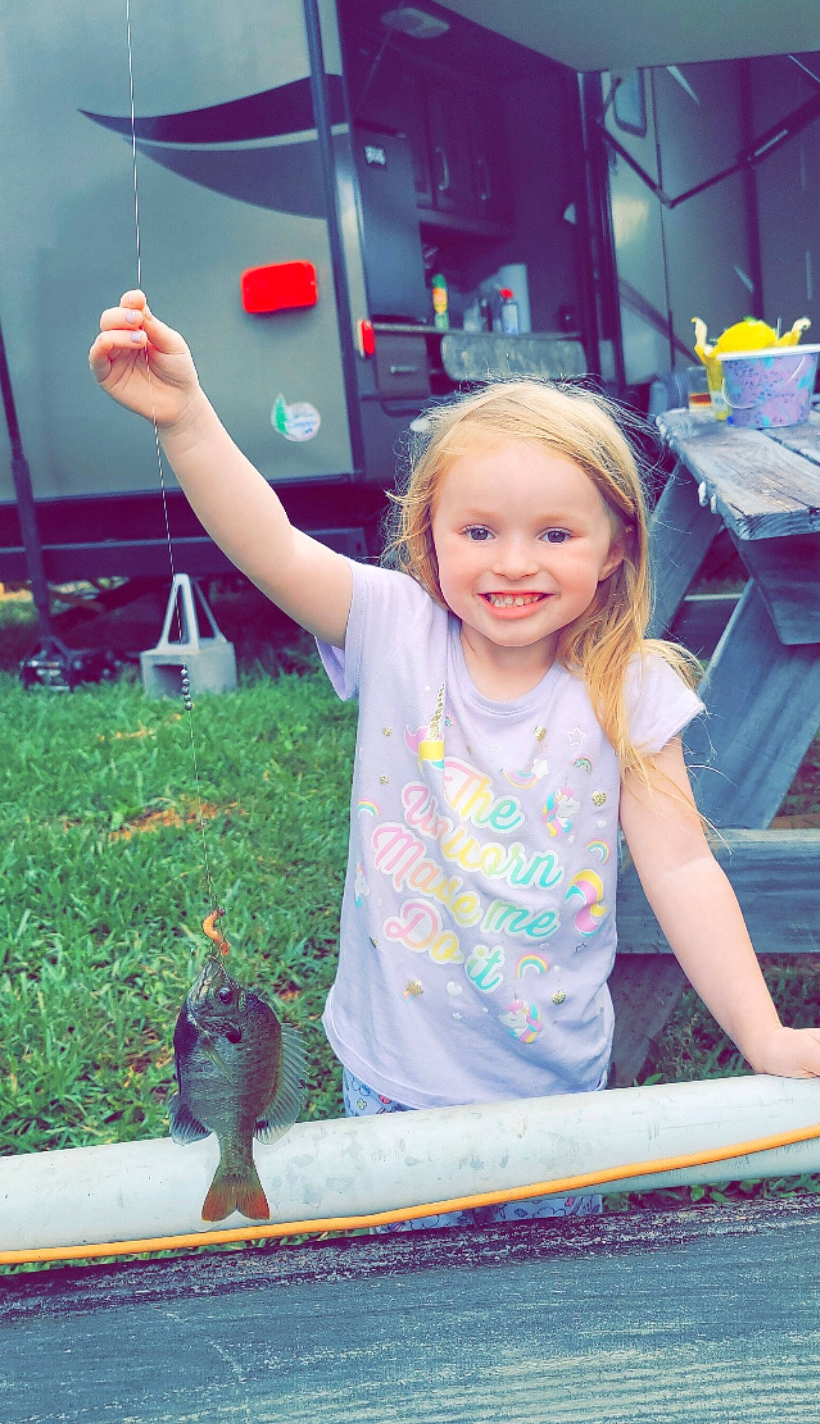 Avelyn is registered to the contest to win money with this photo: child, fun, gesture, grass, happy, joy, leisure, light, person, photograph, pink, plant, recreation, smile, snapshot, summer, t_shirt, thumb, tire, toddler