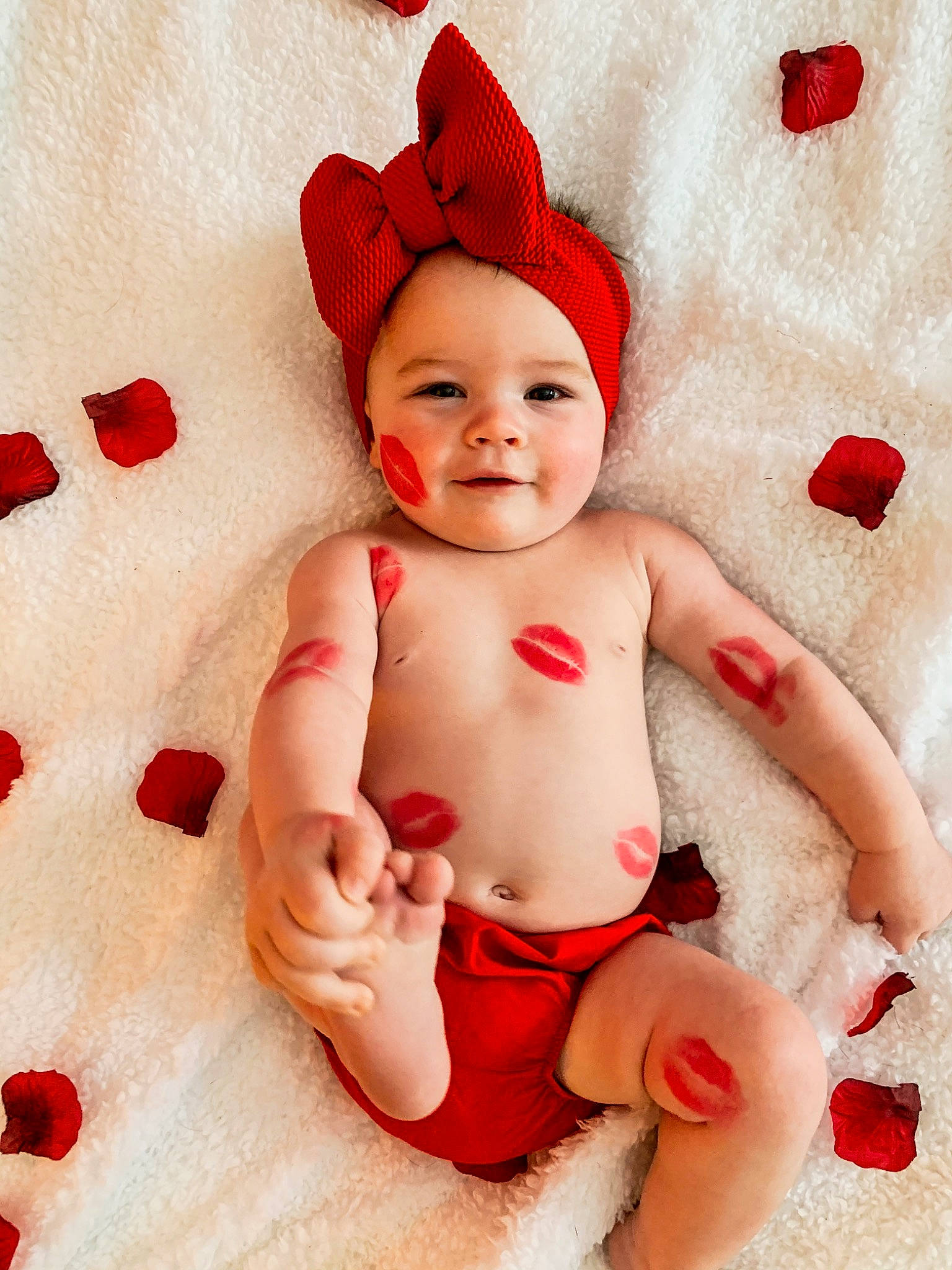 Kimber is registered to the contest to win money with this photo: baby, baby_toddler_clothing, cap, child, costume_hat, face, facial_expression, finger, fun, happy, headwear, holiday, human_body, joy, person, pink, red, skin, smile, stomach