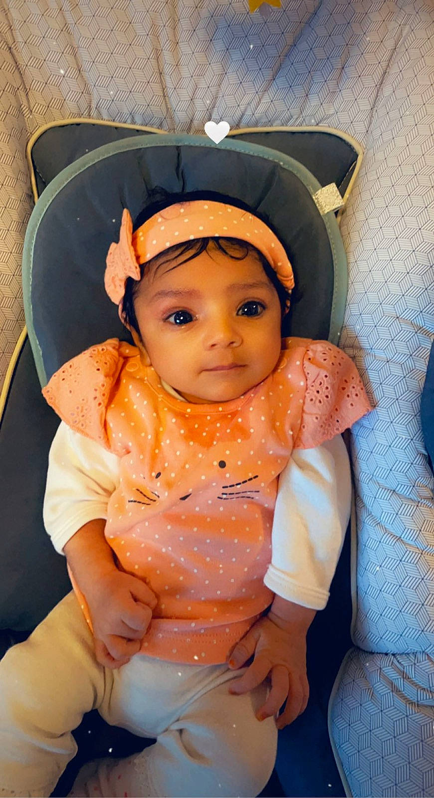 Nour participe au concours pour gagner de l'argent avec cette photo : baby, baby_toddler_clothing, cap, chair, cheek, chin, comfort, eye, eyebrow, eyelash, fun, headwear, iris, lip, mouth, nose, orange, person, skin, sleeve